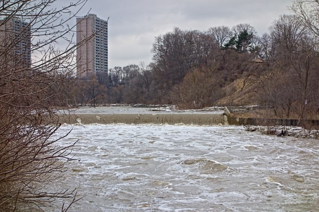 Chunks of ice are carried over the weir.