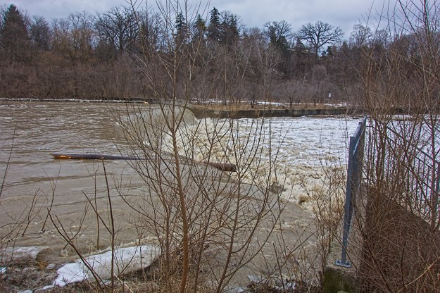 Huge amounts of lumber are being transported - a log is just about to go over the weir.