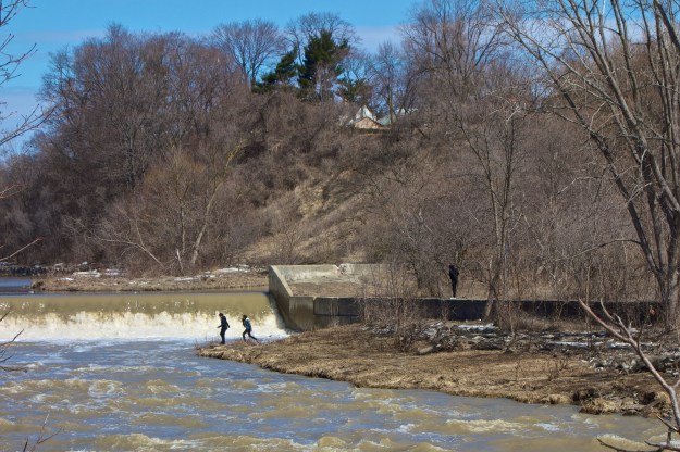 Students from a nearby school help give some scale to the weir.