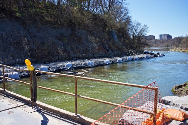 The retaining wall base has been wrapped in plastic.