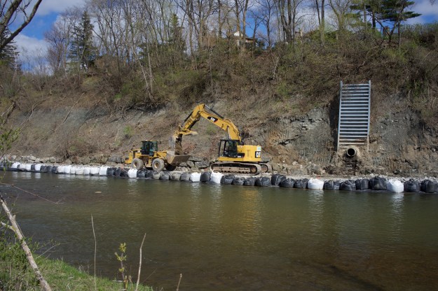Material being removed from the foundation of the new retaining wall.